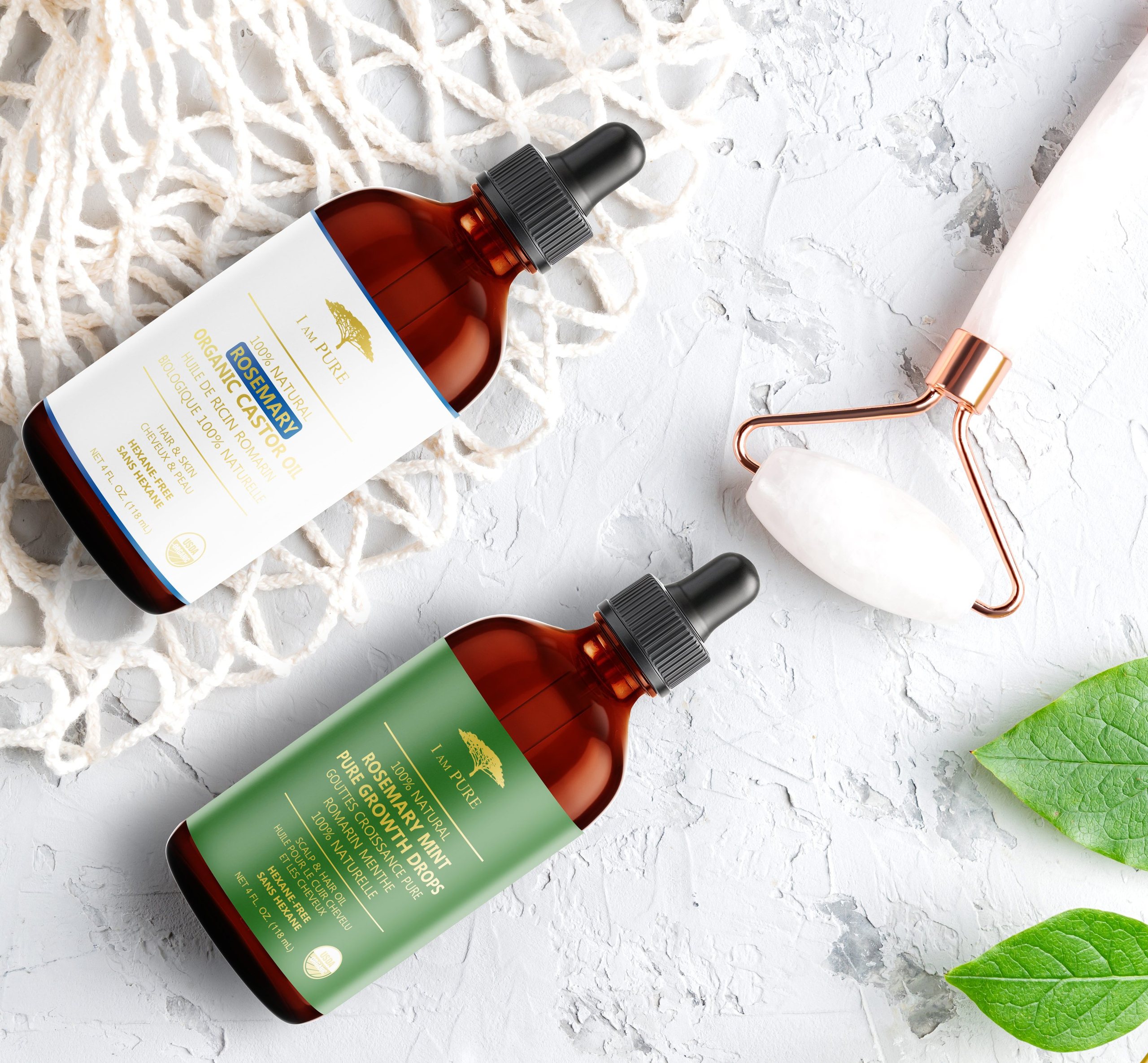 IAMPURE castor oil bottles with fresh leaves and a face roller