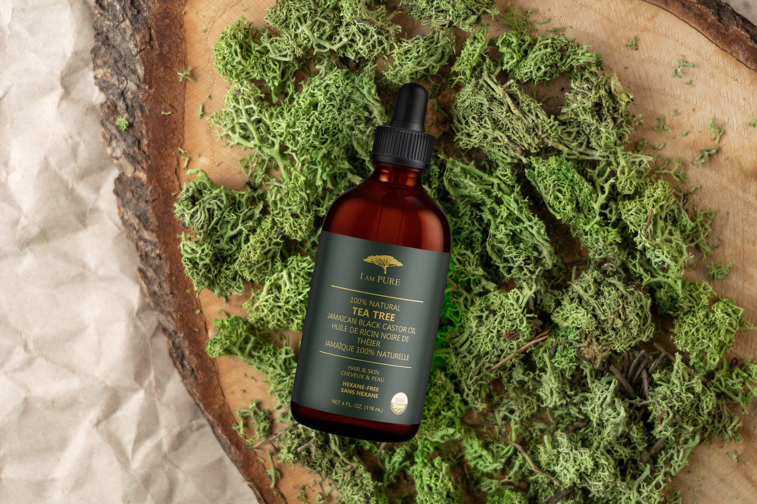 IAMPURE Tea Tree oil resting on moss