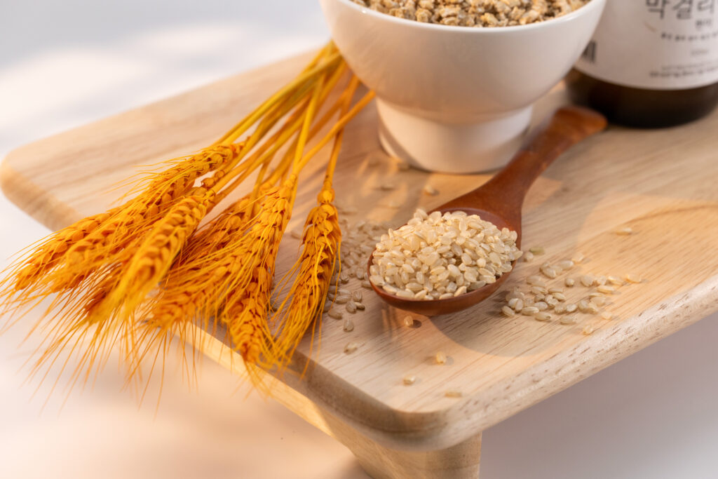 Brown rice and wheat on a wooden tray