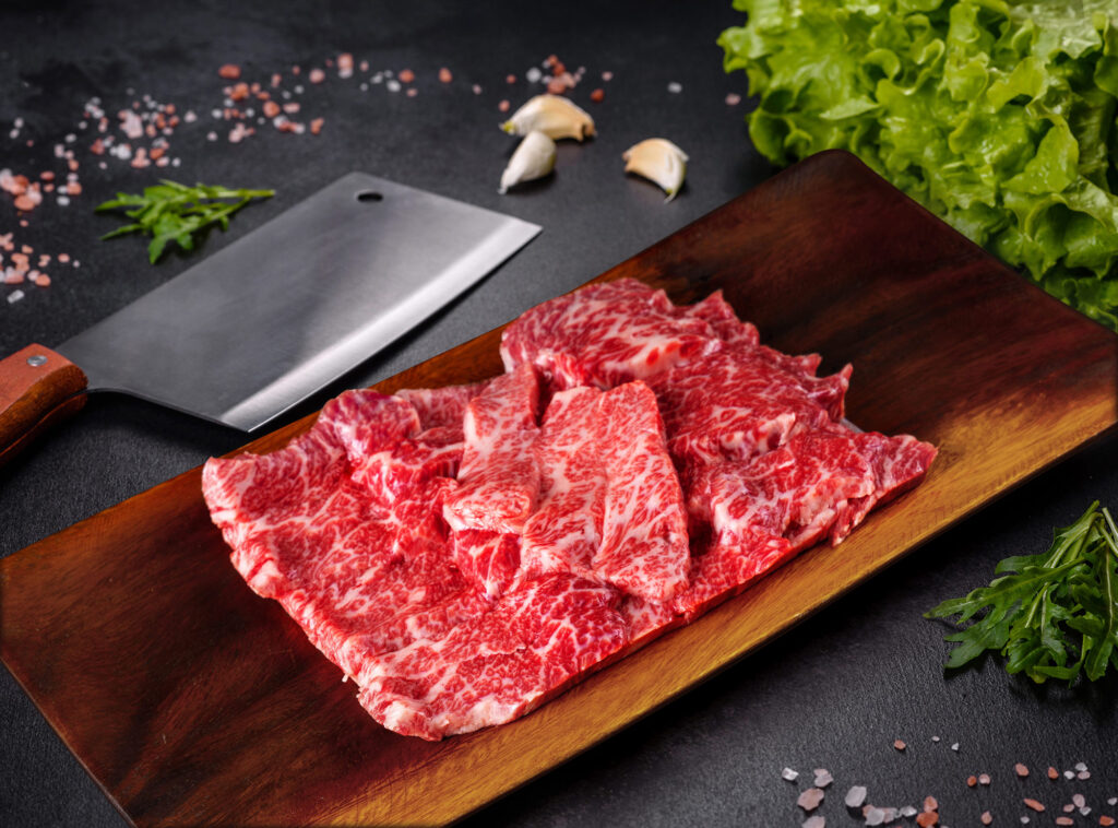 Sliced marbled Hanwoo with a cleaver