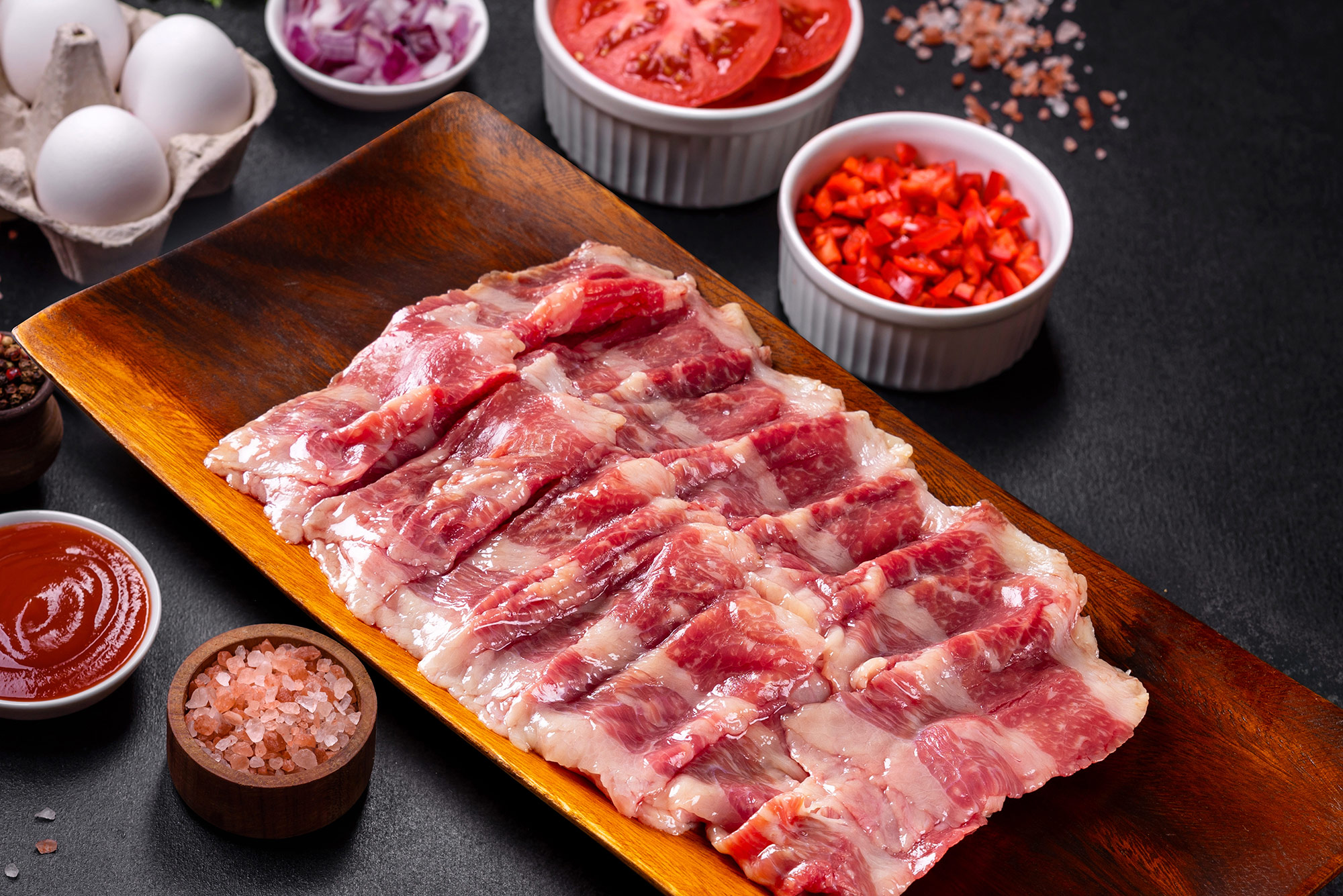 Thin-sliced Hanwoo on a wooden tray