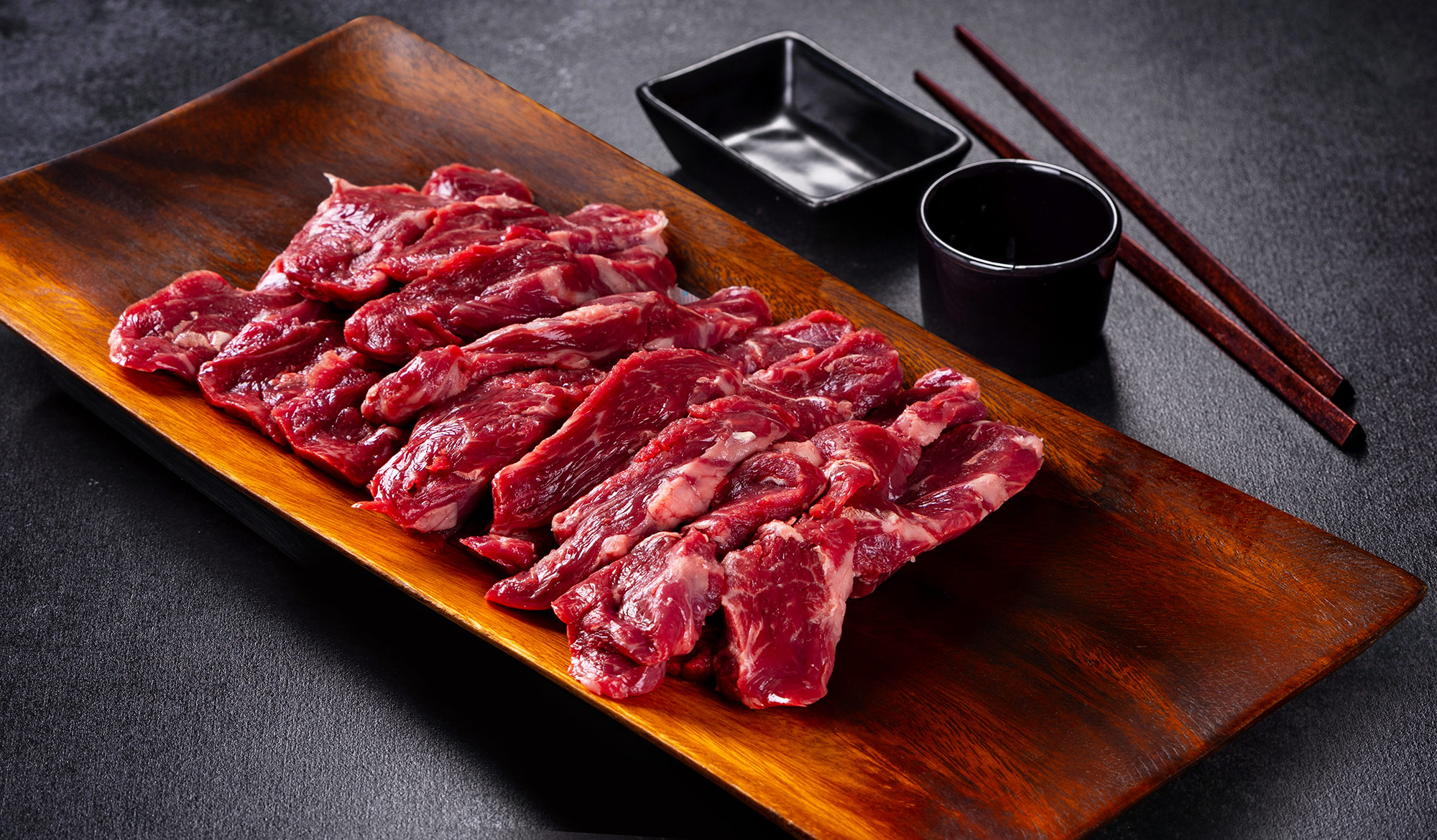 Thin-sliced Hanwoo with chopsticks